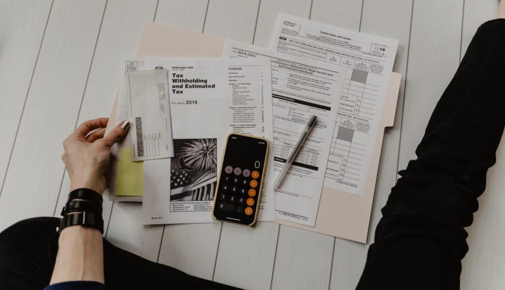 small business owner reviewing GST invoices and paperwork for return filing