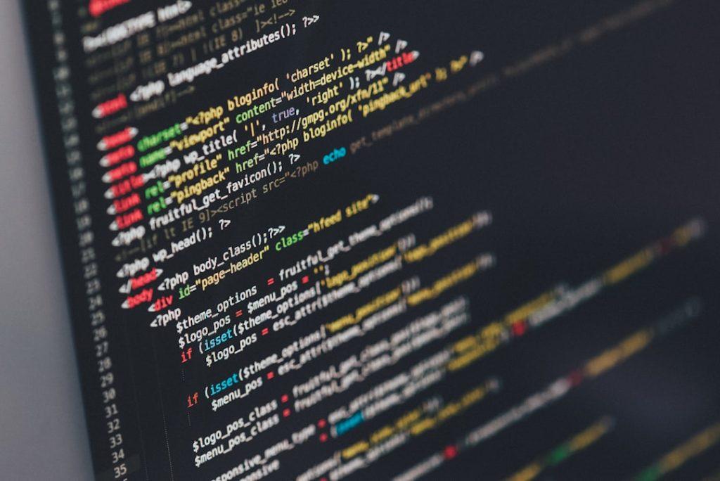 Native app development vs hybrid app code on a developer's screen